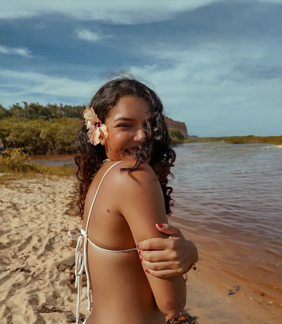 Mulher numa praia exposta ao sol durante o verão